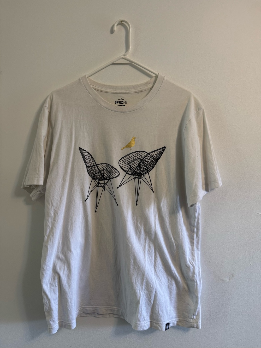 Uniqlo White Tee with Black Chair Graphic and Gold Bird